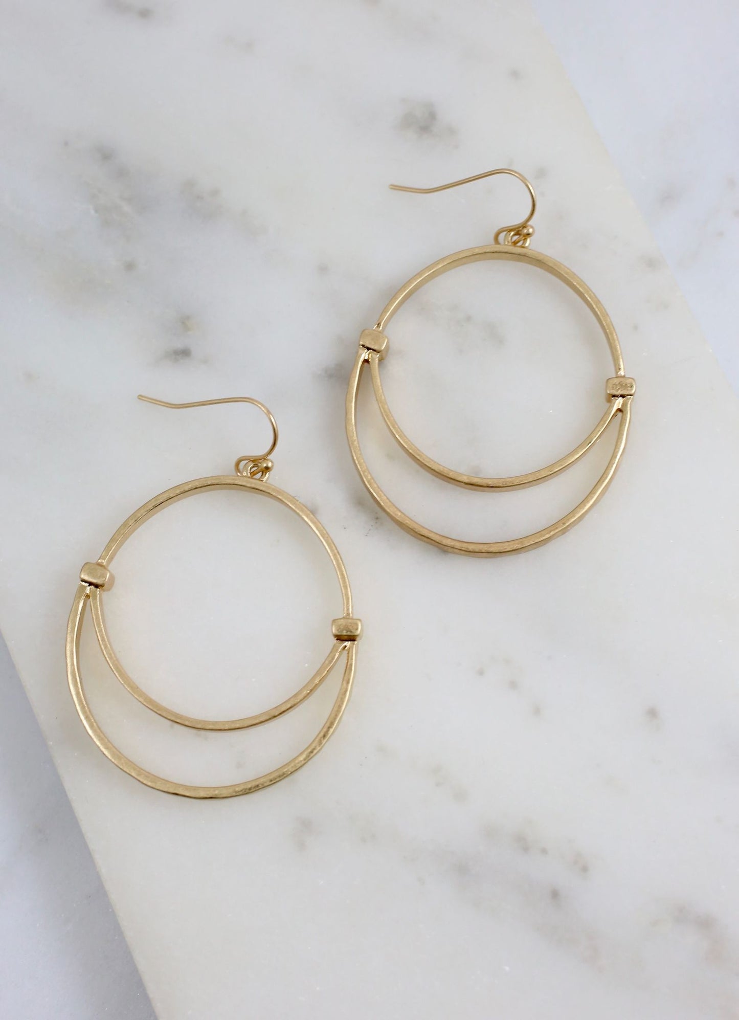 Worn gold earrings